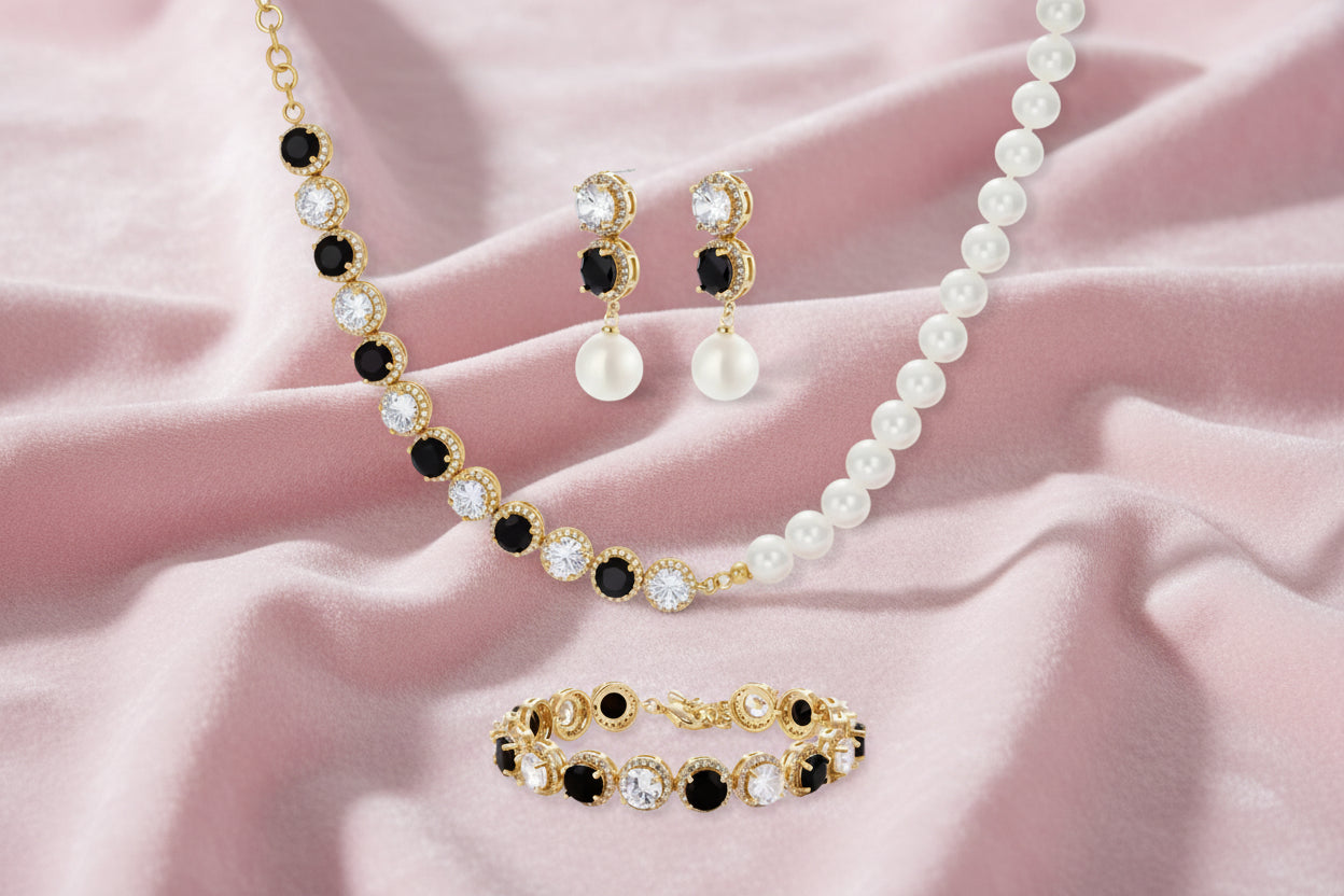 Gold-plated jewelry set with alternating black and clear cubic zirconia stones, featuring necklace, earrings and bracelet