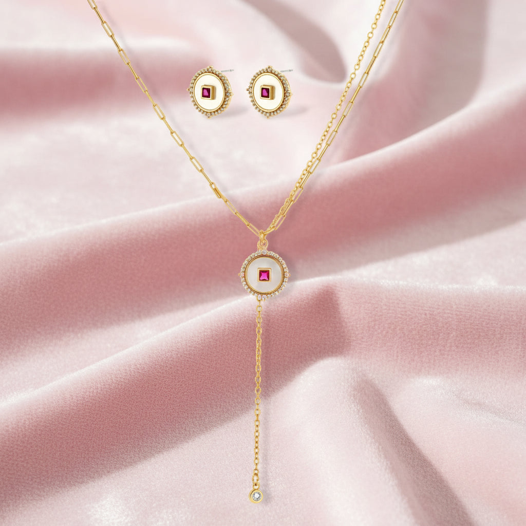 Gold-plated circular medallion necklace set with white enamel base and pink cubic zirconia accent stones