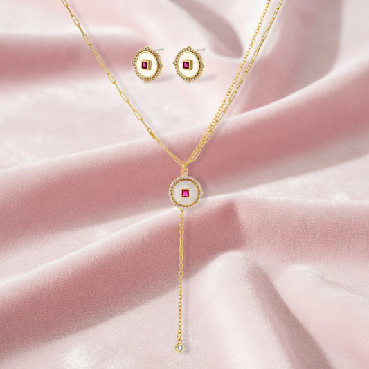 Gold-plated circular medallion necklace set with white enamel base and pink cubic zirconia accent stones