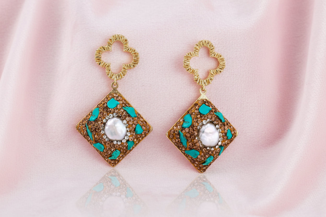 Gold-plated drop earrings with quatrefoil studs, diamond-shaped pendants featuring baroque pearls, turquoise stones, and amber crystals