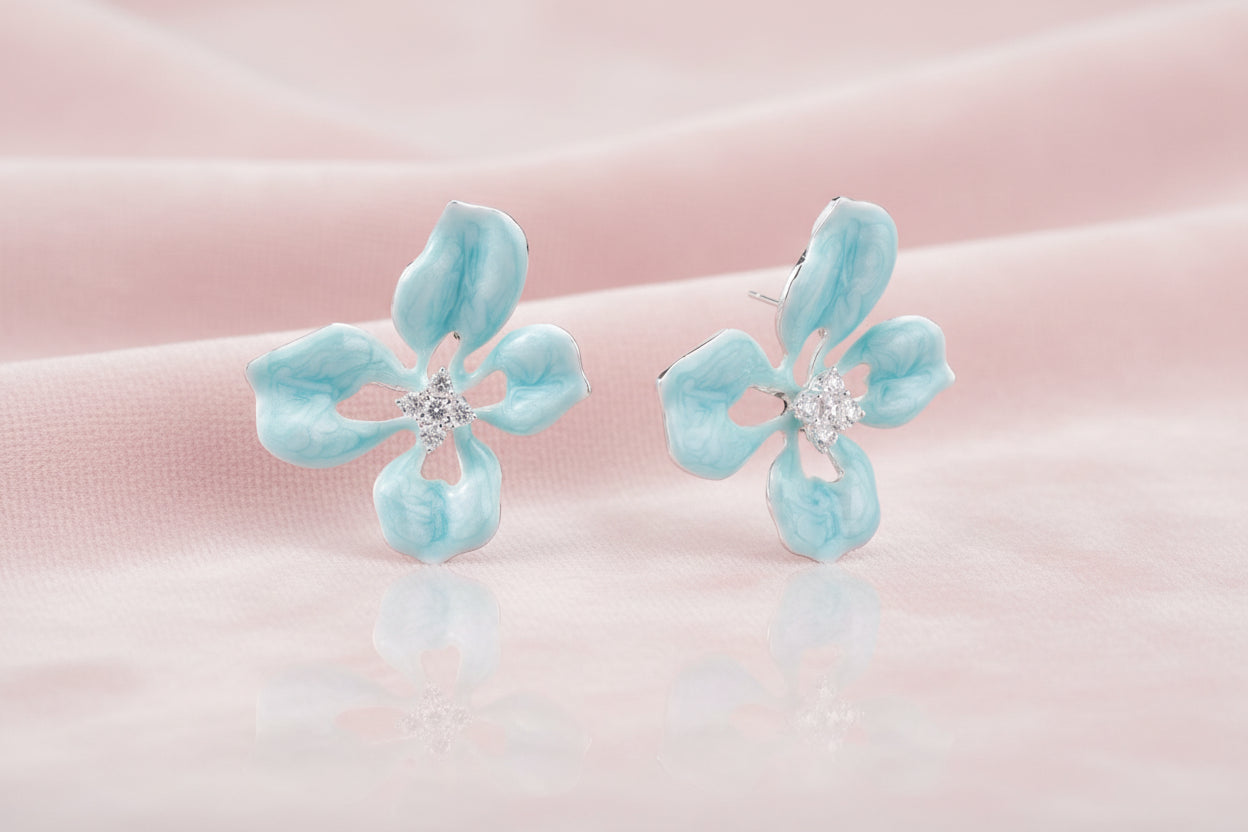 Turquoise enamel flower stud earrings with marbled finish and crystal centers on 18K gold plated brass