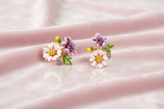 Cluster-style stud earrings with purple pansies, white daisies, yellow centers, and green leaves in glossy enamel finish
