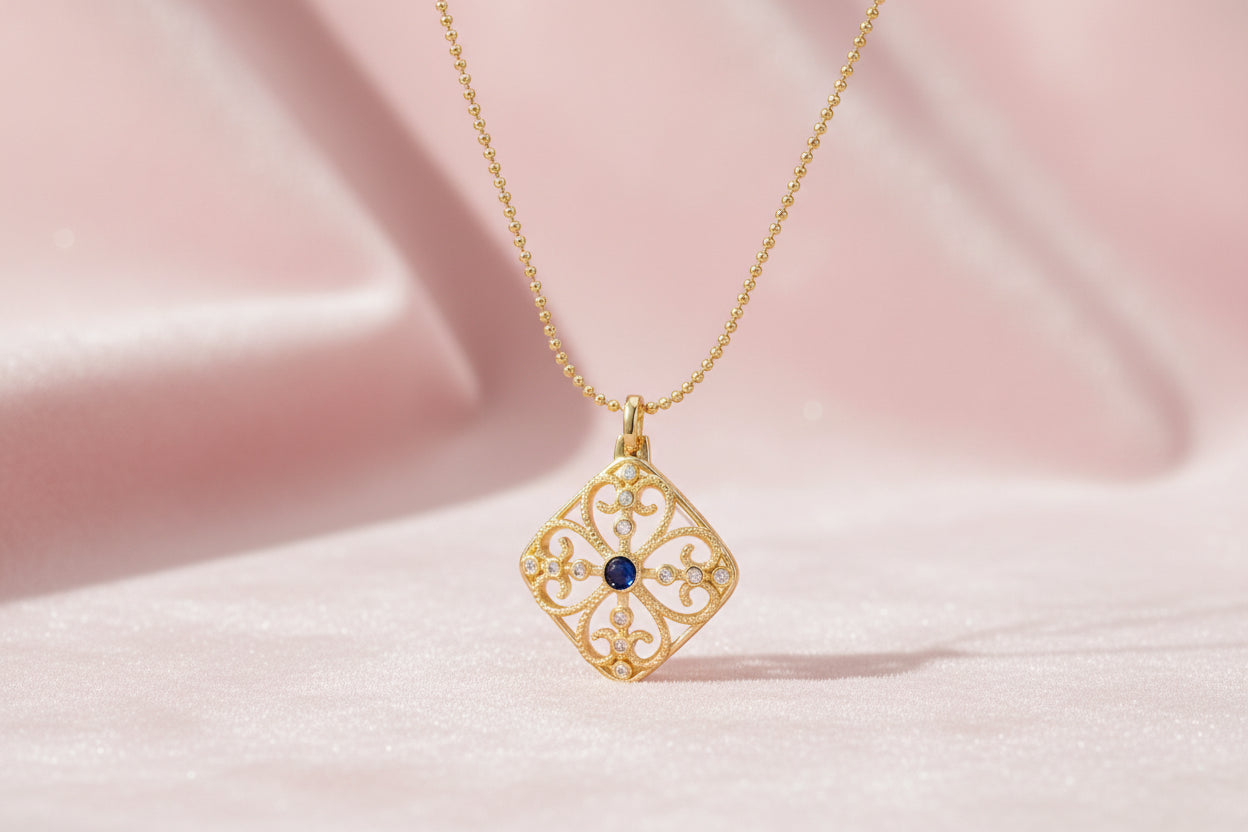 Gold filigree pendant with quatrefoil design, deep blue lapis lazuli center, clear crystal accents on ball chain