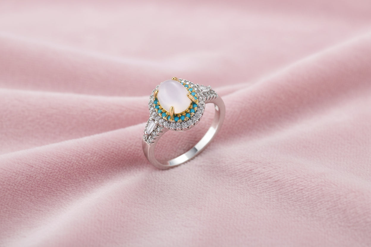 Vintage-style cocktail ring with luminous cat's eye center stone surrounded by turquoise and crystal double halo on white gold plated band