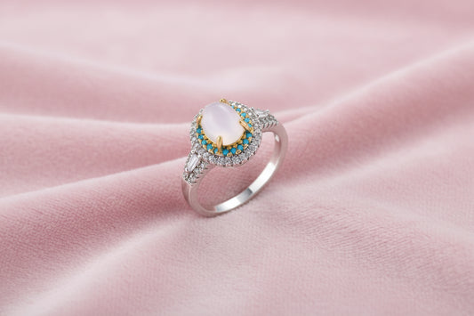 Vintage-style cocktail ring with luminous cat's eye center stone surrounded by turquoise and crystal double halo on white gold plated band