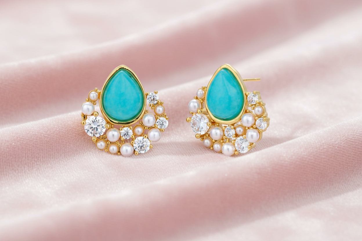 Gold-plated cluster earrings with teardrop turquoise stones surrounded by white pearls and clear crystals