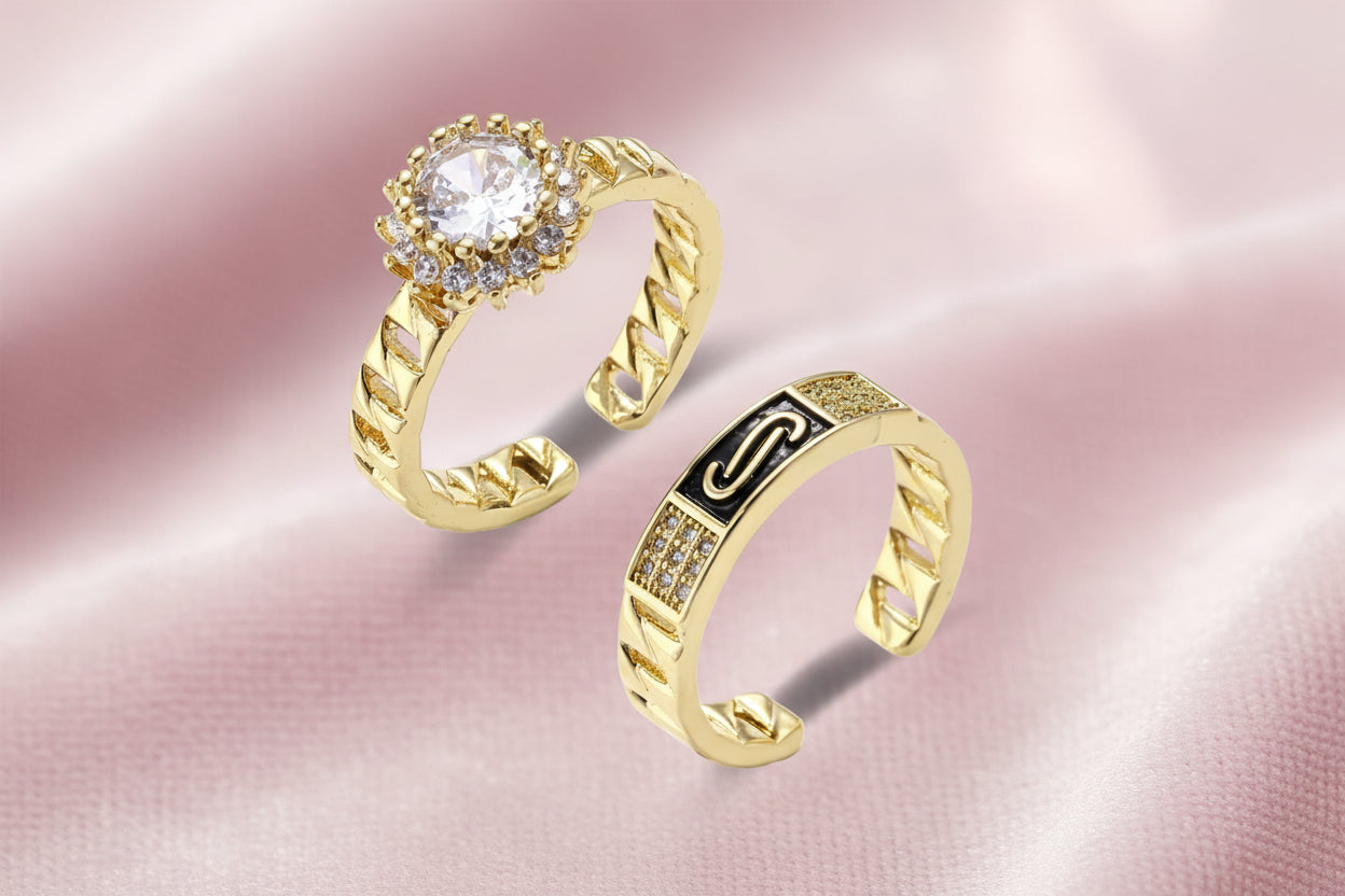 Gold-plated adjustable ring with twisted chain band, central cubic zirconia stone surrounded by crystal halo on cream background