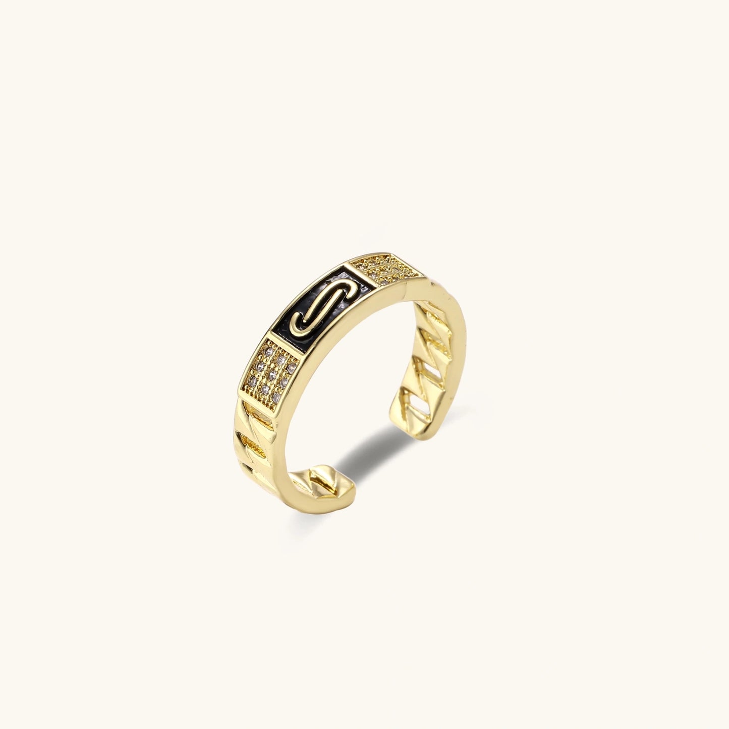 Gold-plated adjustable ring with twisted chain band, central cubic zirconia stone surrounded by crystal halo on cream background